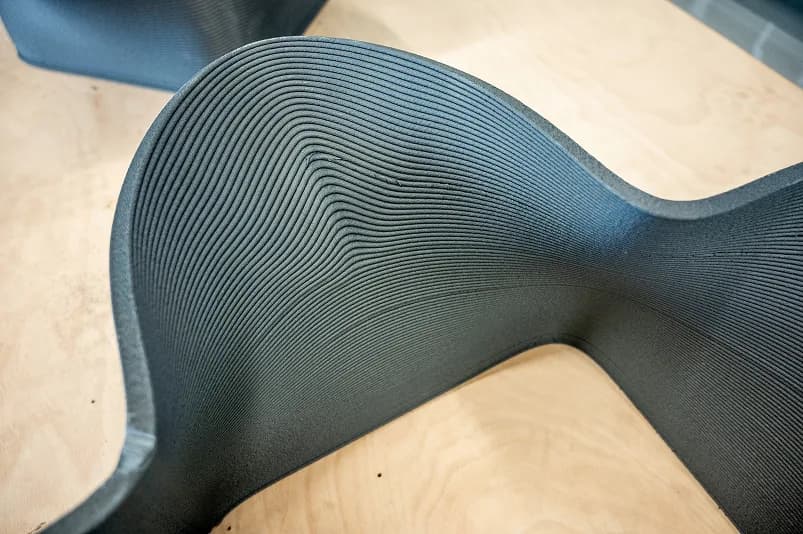 Close-up of a large 3D-printed part with visible pellet extrusion layer lines