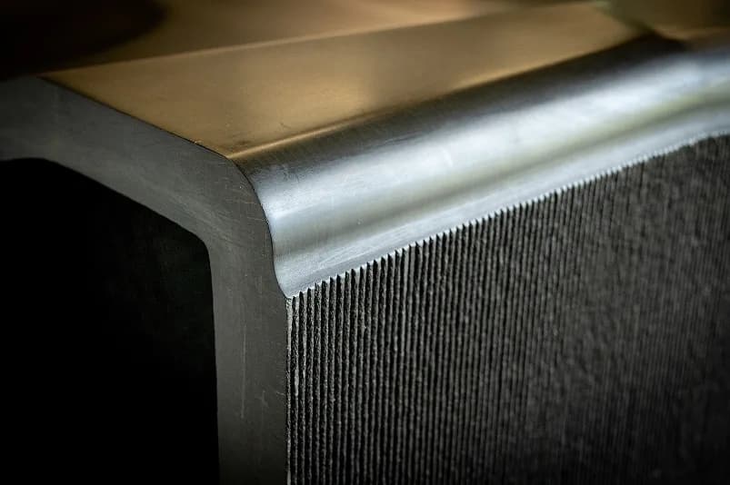Corner detail of a printed part showing as-printed texture beside a machined finish