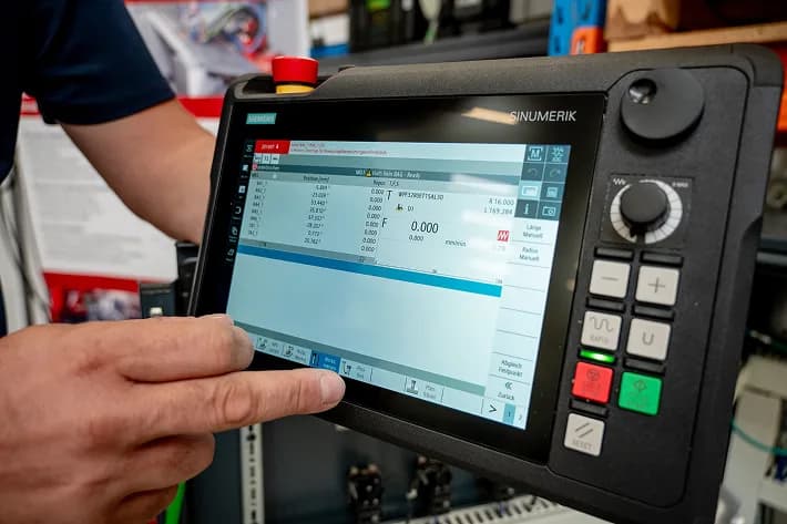 Operator using SINUMERIK ONE control panel on SinuMill 2000